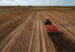 tractor soil aerator plowing field | EZ Machinery
