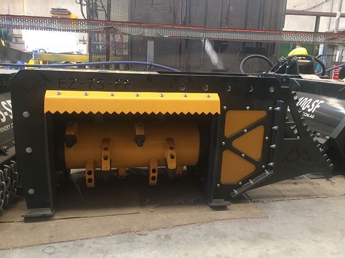 Side view of yellow and black EZ-75-FF fixed flail mulcher indoors