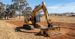 EZ-140-RH rotary hoe attachment fitted to an excavator tilling soil in a paddock in regional Queensland